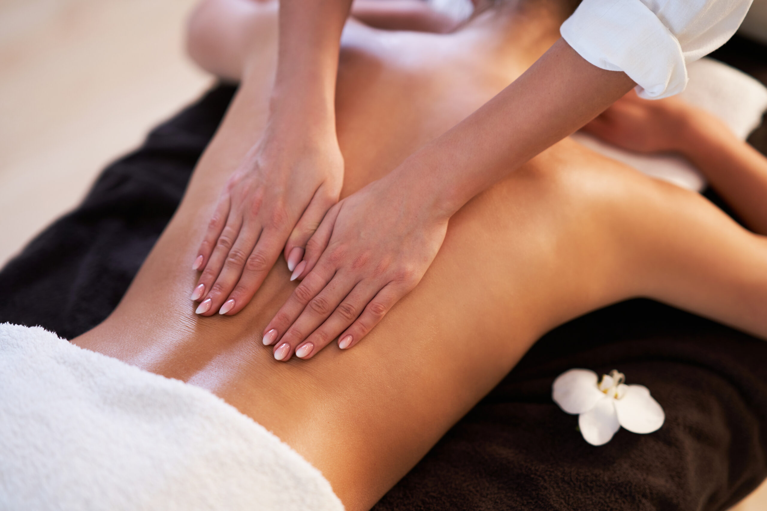 Relaxed,Woman,Receiving,Back,Massage Massage therapist applying pressure during Asian therapy session