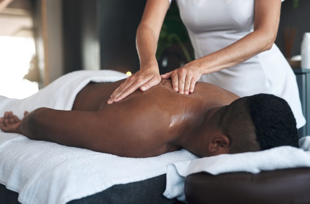 Therapist massaging client’s back