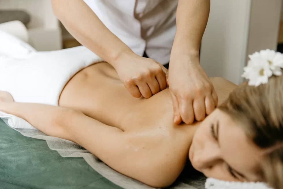 Therapist applying deep pressure during Asian massage