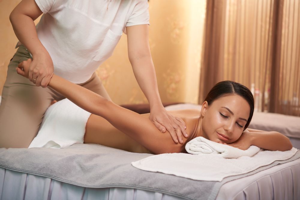 Therapist performing full body massage in Venice Blvd spa