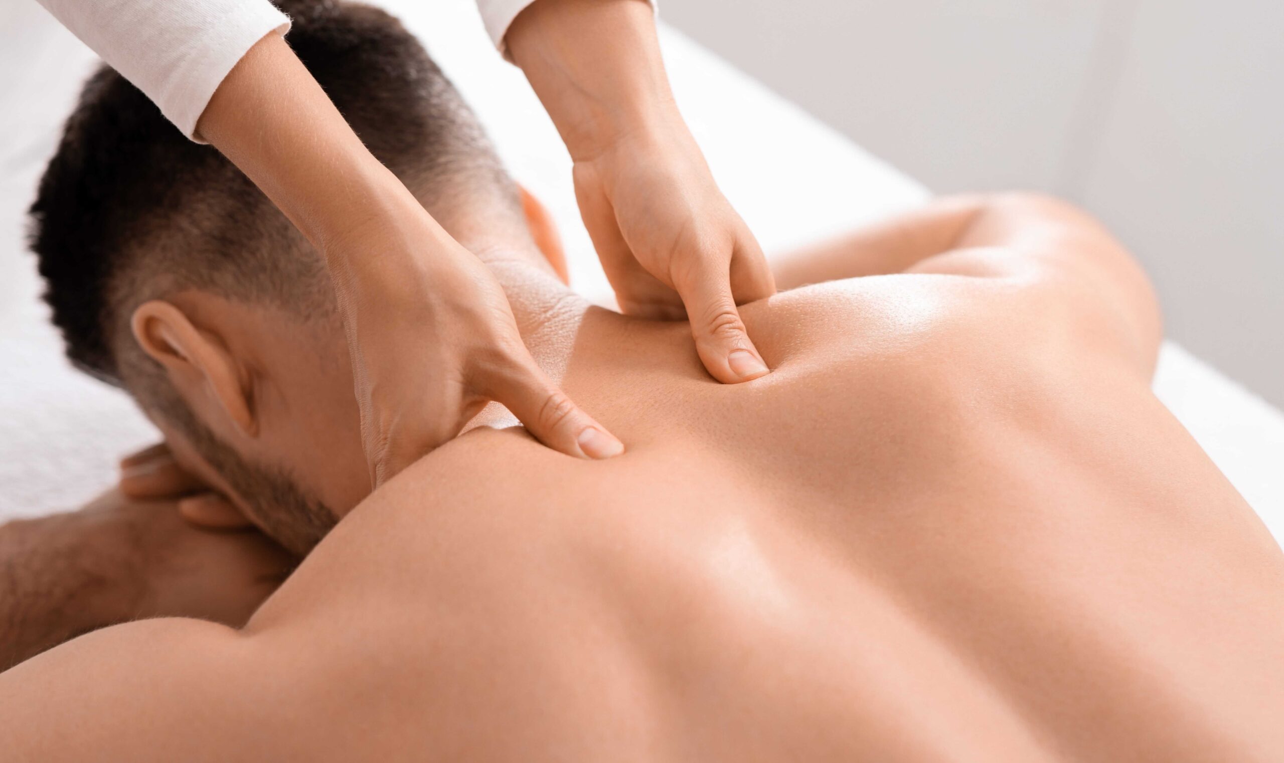 Deep tissue massage relieving shoulder and neck tension